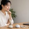 電池式マウスとUSB充電式マウス、ケーブル、受信機を机上で確認する女性